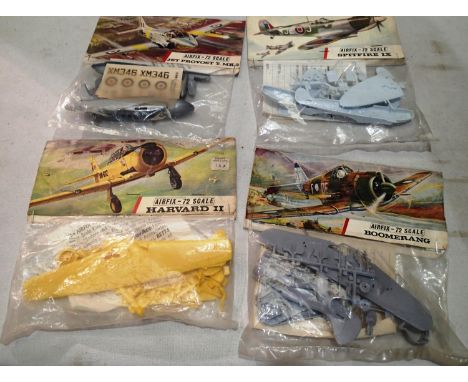 Four early Airfix aircraft kits, bags/header, Harvard, Boomerang, Jet Provost, Spitfire, appear complete/unchecked. UK P&amp;