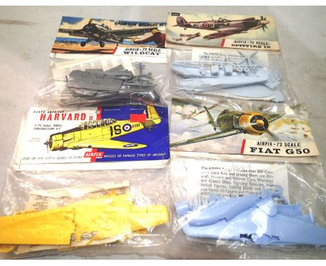 Four early Airfix bagged aircraft kits, Spitfire, Wildcat, Fiat G50, Harvard, appear complete/unchecked. UK P&amp;P Group 1 (