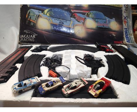 Aurora Jaguar challenge set with four lane Le Mans circuit and four cars with lights, appears in good condition, untested, bo