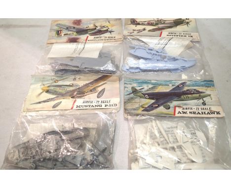 Four early Airfix bagged aircraft kits, Spitfire, Seahawk, Westland Whirlwind, Mustang P51D, appears complete/unchecked. UK P