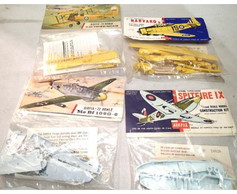 Four vintage Airfix bagged aircraft kits, Harvard, Tiger Moth, Spitfire, BF109G, appear complete/unchecked. UK P&amp;P Group 