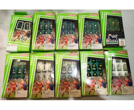 Ten Subbuteo football teams, all complete , some over painting, to create other teams, named on boxed, plus football pitch an
