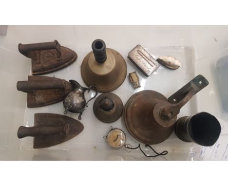 A mixed collection of metalware items to include cast iron flat irons, bronze and brass bells, silver plated dressing table l