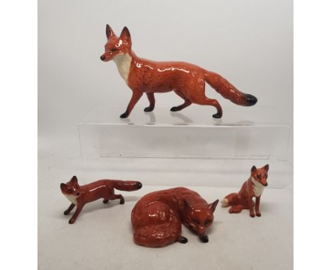 Beswick fox figures to include large standing fox, curled fox, small standing fox and small seated fox (4). 