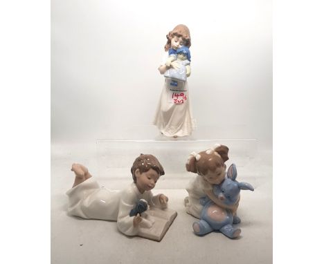 Three Nao figures boy with puppy, girl with doll and girl with soft toy (3). 