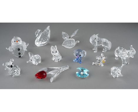 A collection of Swarovski Collector Club /Silver Crystal boxed small models to include: a display tulip with ruby petals; Sno