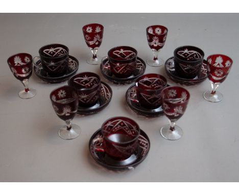 A set of six Bohemian ruby glass teacups and saucers together with a set of six ruby flash glass port glasses (Q) 