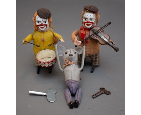 Three vintage Schuco (German) tinplate wind up clockwork toys to include:  Drummer Clown wearing ocre yellow felt jacket, bei