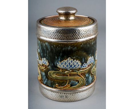 An Art Nouveau Royal Doulton silver-mounted cylindrical tobacco jar and cover, raised sinuous floral motifs on a mottled grou