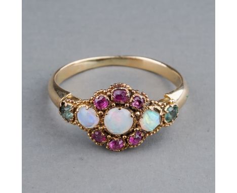 An early 20th century yellow gold opal cluster ring, set with three round cabochon opals within a ruby border, green stones s