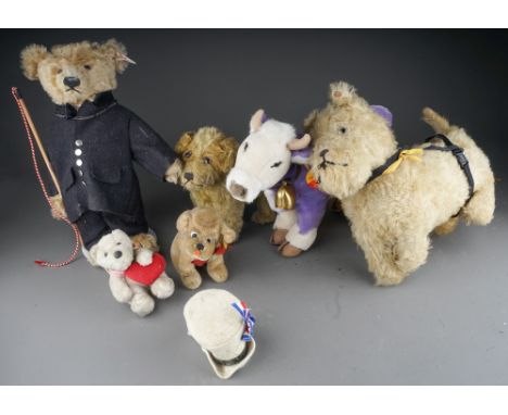 A Steiff purple Milka cow, a Steiff bear, two cuddly dogs etc 