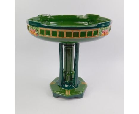 An early 20thC Eichwald pottery comport, moulded with flowers, the circular top raised on a column with four buttress support
