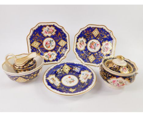 A Ridgways early 19thC porcelain part tea service, painted with reserves of flowers against a cobalt blue ground, gilt height