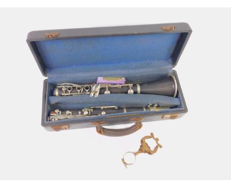A Selmer centred tone two piece clarinet, with sheet music grips and reeds, cased.