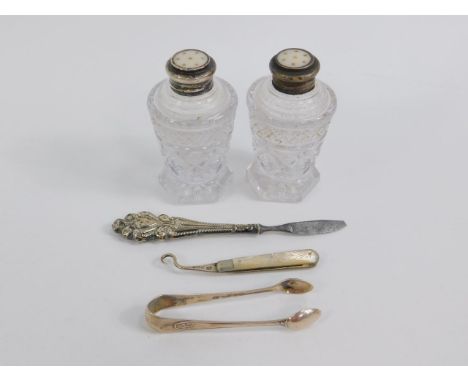 An Edward VII silver and mother of pearl folding button hook, Sheffield 1904, manicure implement, pair of silver sugar tongs,