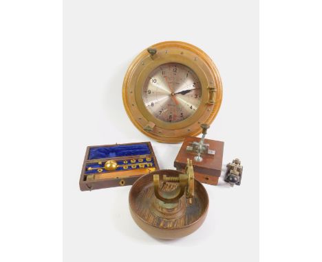 A brass and oak framed ship's line quartz wall clock, capstan wheel nut cracker, Sykes hydrometer and two Morse code machines