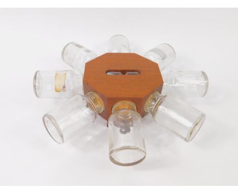 A vintage mahogany cased spice rack, of octagonal wall mounted form, inset an hour glass, with eight glass jars, 31cm diamete
