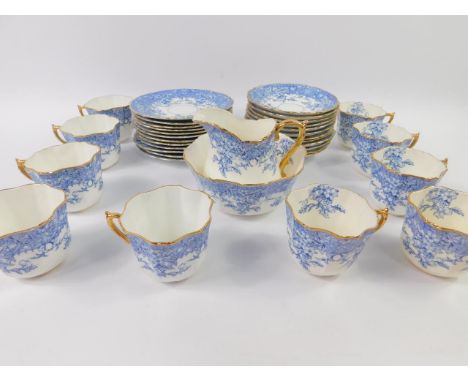 A late 19thC Wileman & Co porcelain part tea service, transfer decorated in blue with flowers, comprising cream jug, sugar bo