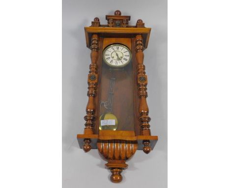 A late 19thC walnut and oak Vienna wall clock, enamel dial bearing Roman numerals, eight day movement with coil strike, the c