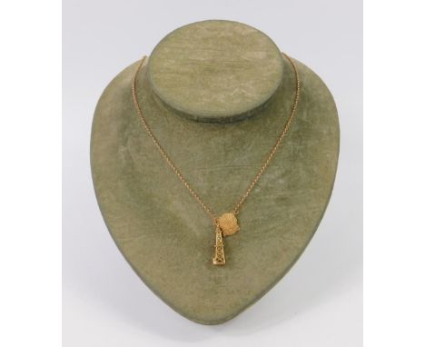 A 9ct gold 10 anos scallop shell pendant, on a belcher link neck chain with an openwork tower charm, stamped 18ct, 7.5g. 
