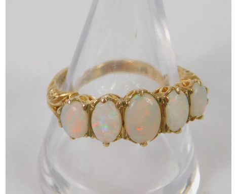 A 9ct gold and opal five stone ring, size P, 3.4g. 