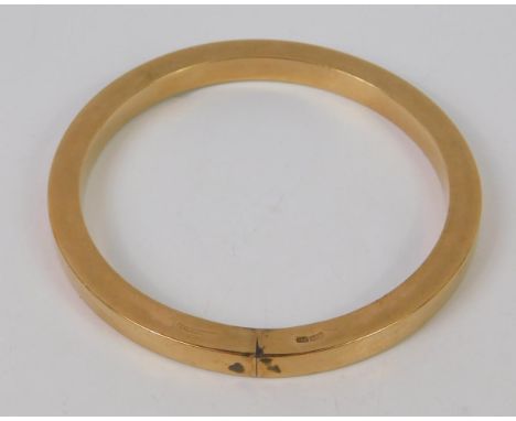 A bangle of plain circular hollow design, yellow metal, stamped 9ct, 21.1g. 