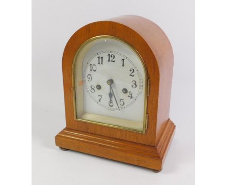 A German early 20thC oak cased mantel clock, enamel dial bearing Arabic numerals and Wurtemberg, eight day movement with coil