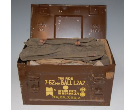 An ammunition trunk containing various post WW II webbing etc.