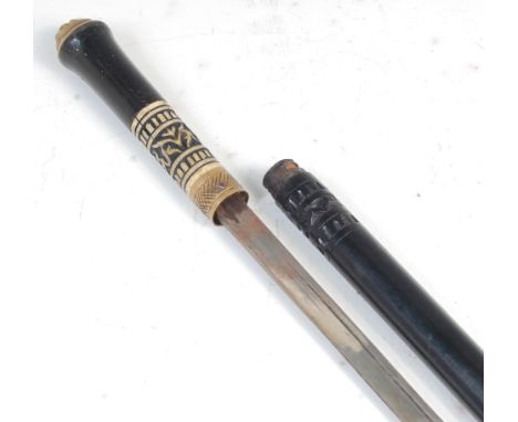 A late 19th century sword stick, the ebony shaft revealing a 61cm single edged blade, having a brass locking ring and bone in