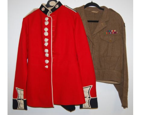 A Coldstream Guards red felt tunic having white facings with brass buttons, bearing a label for the Royal Army Clothing Facto