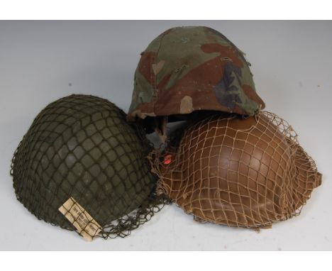 A U.S. Army ground troops combat type 1 helmet, together with a British army tin helmet and one other. (3)
