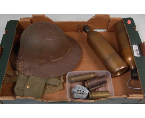 A WW I steel helmet together with WW II gaiters, webbing pouches and water bottles etc.