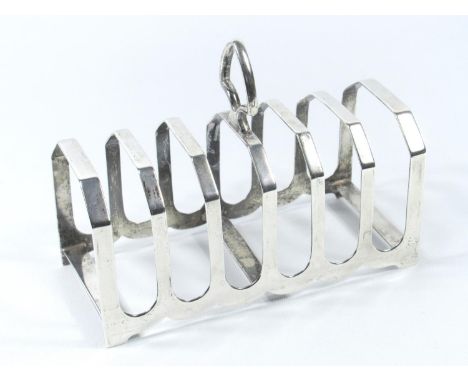 SILVER SIX DIVISION TOASTRACK BY E. VINER, SHEFFIELD, 1932, (W. 14 CM) 142.8 GRAMS AND A SILVER THREE LIGHT CANDELABRUM WITH 