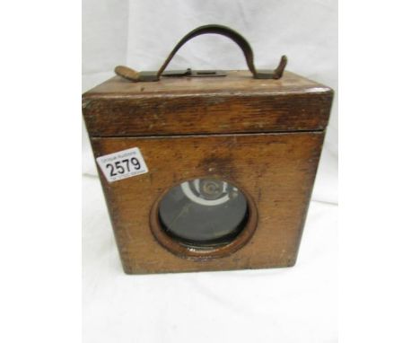 An oak cased pigeon timing clock.