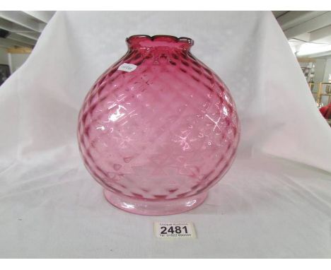 A cranberry glass lamp shade, in good condition.