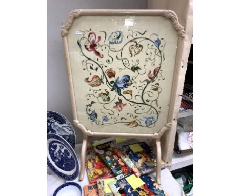 A vintage folding fire screen/coffee table with painted floral decoration