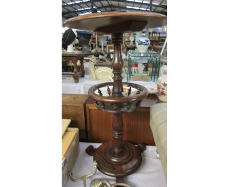 A Victorian circular mahogany lamp table with Bobbin turned needlework gallery on circular base painted to simulate rosewood