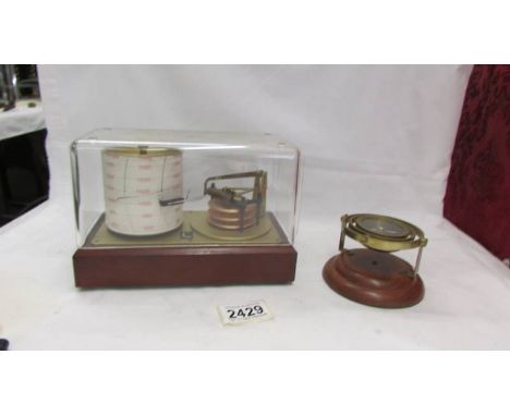 A small barograph and a brass compass.