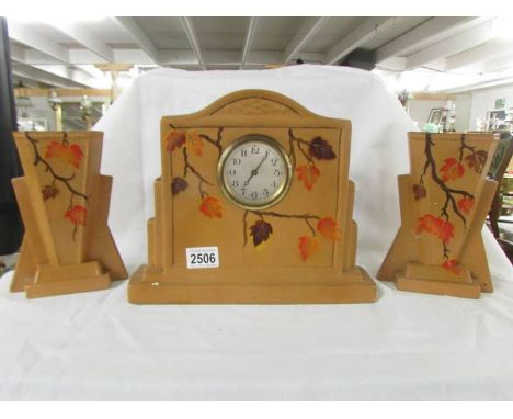 A 1930's ceramic clock garniture.