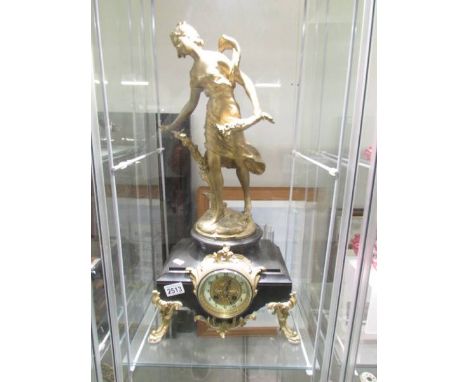 A 19th century French marble and gilt mantel clock surmounted female figure.