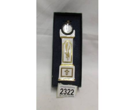 A boxed ceramic fob watch stand in the form of a Grandfather clock complete with watch.