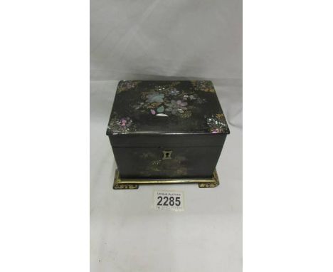 A late Victorian black lacquer tea caddy inlaid with mother of pearl. ****Condition report**** Mother of pearl&nbsp;inlay in 