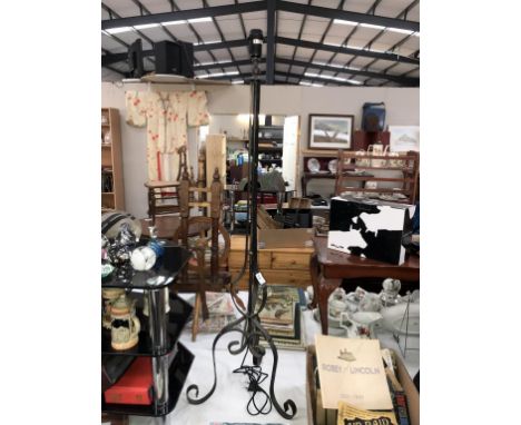 A wrought iron floor standing lamp (fitted with 2 pin plug)