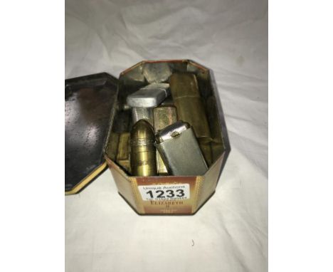 A tin of vintage lighters including French art etc
