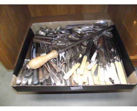 A box of vintage flatware cutlery