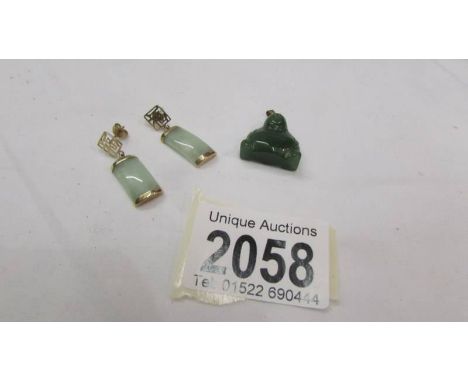 A pair of jade earrings and a jade Buddha pendant.