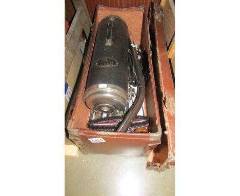 A vintage Swan vacuum cleaner in old leather case