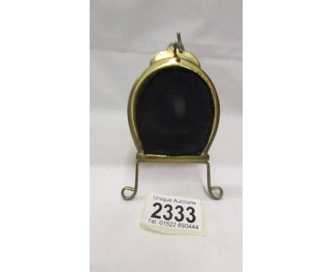 A brass easel pocket watch stand.