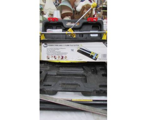 A tool box, tile cutter and other tools. (Collect only)