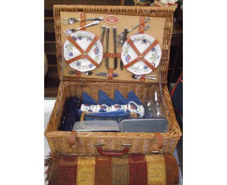 A wicker picnic basket, 2 backpack picnic sets, a small 2 person set plus a vintage set (vintage set missing some contents)